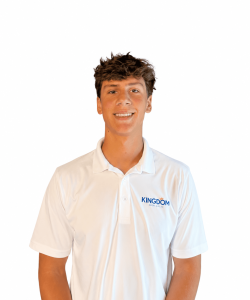 Young man in a white "Kingdom" polo shirt standing and smiling against a plain white background.
