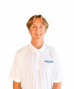 Young person with light brown hair wearing a white "KINGDOM" polo shirt, standing against a plain white background.