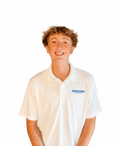 Teen boy with light brown hair wearing a white "Kingdom Lacrosse" polo shirt, smiling against a plain white background.